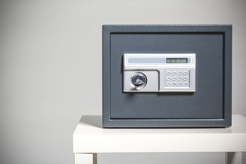 Closed safe on grey background