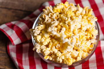 A bowl of popcorn on tablecloth