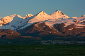 The ray of sunrise in snow-capped mountain of Aragats