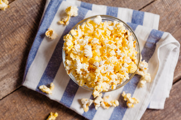 A bowl of popcorn on tablecloth