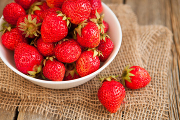 Fresh strawberries on old wooden background