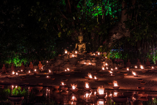 Magha Puja Day. Buddha Surrounded By Candles. Phan Tao Temple