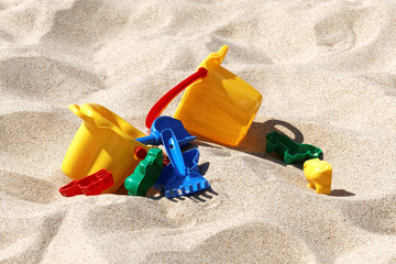 Plastic colored toys in the sand