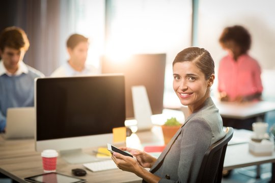 Portrait of businesswoman using mobile phone