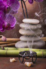 braciere con incenso,pila di pietre con orchidea e bambù © luigi giordano