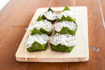 Kanom KUAY, Banana Dessert (Steamed Flour with Coconut Filling wrapped in banana leaf) Thai Dessert