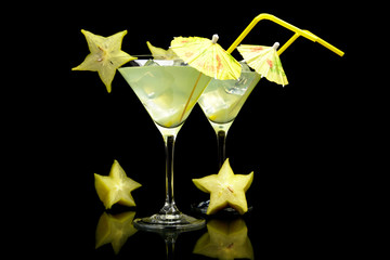 Cosmopolitan margarita drinks with carambola fruit on black