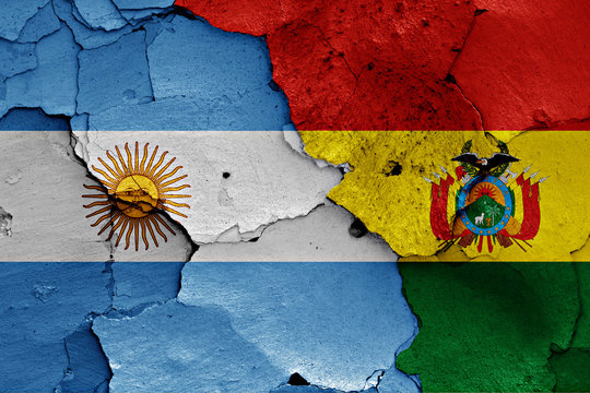 flags of Argentina and Bolivia painted on cracked wall