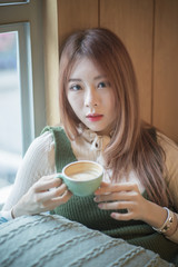 portrait of attractive asian girl in coffee shop