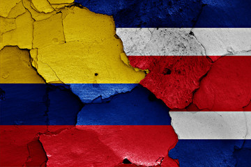 flags of Colombia and Costa Rica painted on cracked wall