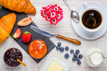 Fototapeta na wymiar Breakfast Table with Coffee and Croissant