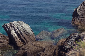 Rocky coastline with turquoise clear water in greek island
