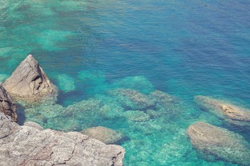 Rocky coastline with turquoise clear water in greek island