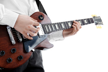 Fototapeta na wymiar Young man playing electric guitar on white background