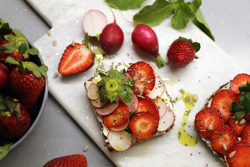 Rye bread with strawberry and radish / Fresh original snack   