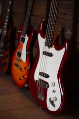 Naklejka na ściany i meble Electric guitars on wooden background, close up
