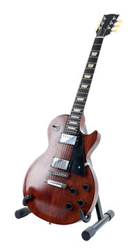 Brown electric guitar on a stand, isolated on white