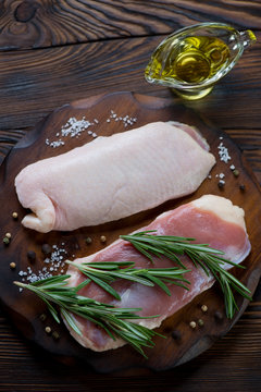 Above view of raw duck breasts and seasonings, studio shot