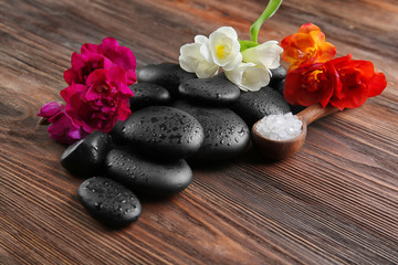 Fototapeta na wymiar Spa stones with salt on wooden background