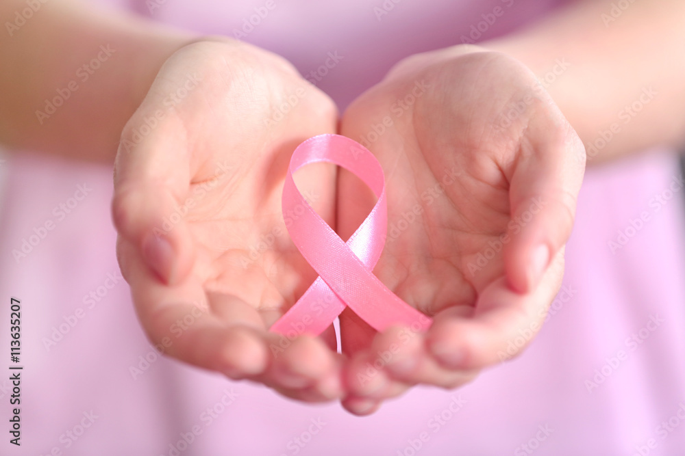 Poster Woman holding pink ribbon. Cancer concept