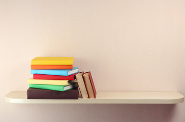 Many books on wooden shelf