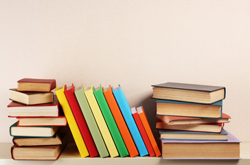 Many books on wooden shelf