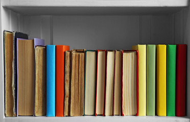 Many books on wooden shelf