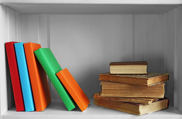 Many books on wooden shelf