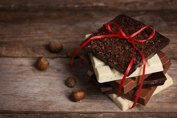 Chocolate bars on wooden background