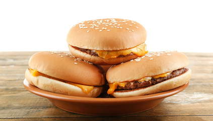 Tasty cheeseburgers on plate, isolated on white