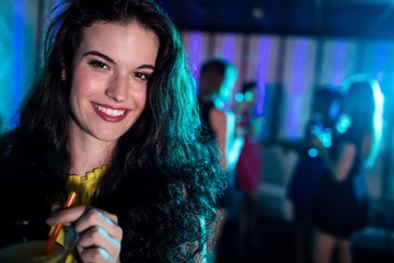 Portrait of young woman having a cocktail