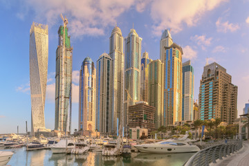 Fototapeta na wymiar Panoramic view of Dubai Marina bay with yacht and cloudy sky, Dubai, UAE