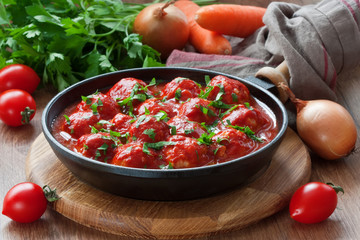 Meatballs in tomato sauce / Delicious chicken or turkey meatballs with rice, vegetable and  tomato sauce in frying pan