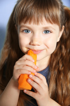 Little girl with carrot, close up