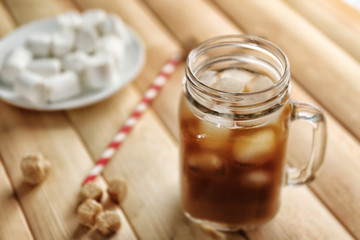 Jar of ice coffee on wooden table