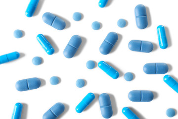 Heap of pills on white table