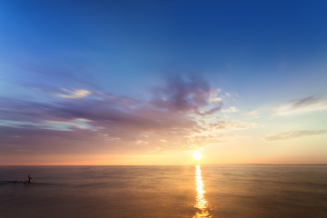 Obraz premium sunrise on the water / Early summer morning bright sky Beach