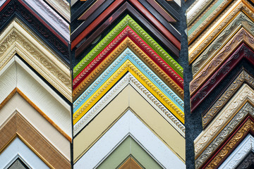 Craftsman working on frame in frame shop. Professional framer hand holding frame angle. Top view