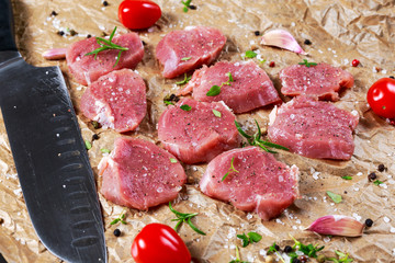 Raw pork tenderloin on crumpled paper. ready to cook.