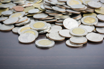 Money thai coins ( bath) staircase sorted on wooden table. The c