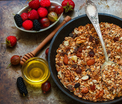 Homemade granola with raisins, walnuts, almonds and hazelnuts. Muesli and honey . Fresh berries - raspberry, strawberry, gooseberry, mulberry. Healthy Breakfast
- Powered by Adobe