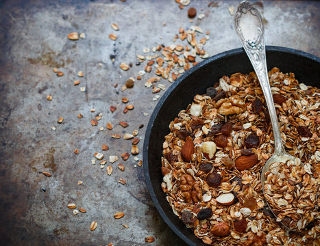 Homemade granola with raisins, walnuts, almonds and hazelnuts. Muesli. Healthy Breakfast. Top view. Copy space