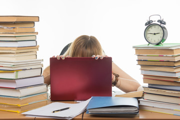 Student in despair laid her head on laptop