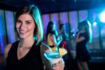 Portrait of young woman having a cocktail 