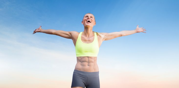 Composite image of fit woman celebrating victory with arms stretched