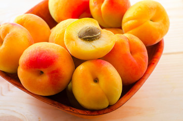 Organic apricots  on wooden background.
