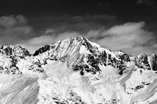 Fototapeta Black and white snowy mountains at sun day