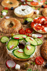 Delicious Bagel sandwiches with soft cheese, chorizo, vegetables. selected focus