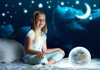 Naklejka premium Girl in her bed and glowing globe