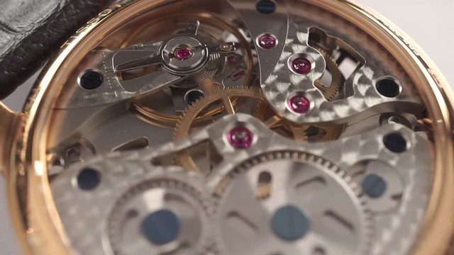 Expensive wrist watch mechanism in action, close up dolly video